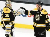  ?? MICHAEL DWYER/AP ?? Boston Bruins’ Linus Ullmark, left, and Patrice Bergeron celebrate after defeating the Tampa Bay Lightning during the third period on Saturday in Boston.