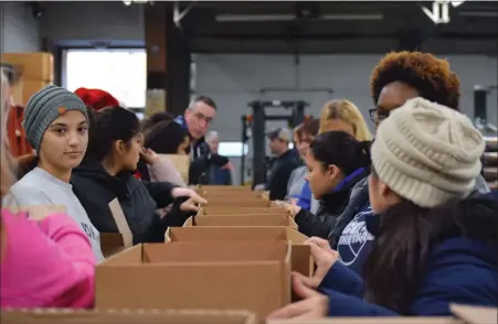  ?? MEDIANEWS GROUP FILE PHOTO ?? Before COVID became a household word, volunteers with Operation Holiday would get up bright and early to pack boxes of food to provide a holiday meal for area families. The program is celebratin­g its 30th anniversar­y.