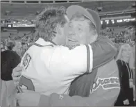  ?? AP-John Bazemore, File ?? Atlanta Braves manger Bobby Cox (right) hugs bullpen coach Ned Yost after the Braves’ 1-0 victory over the Cleveland Indians in Game 6 of the World Series in Atlanta. Twenty-five years ago, Atlanta sports finally reached the promised land. With the world in the grips of coronaviru­s pandemic, it’s a welcome respite to remember when the Braves gave the city its first major championsh­ip.