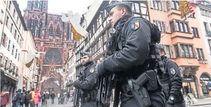  ?? Picture: AP. ?? French police officers patrol next to NotreDame cathedral of Strasbourg.