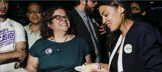  ??  ?? In this June 27, photo provided by Ocasio2018, Alexandria Ocasio-Cortez (right) 28, celebrates her Democratic congressio­nal primary victory over 10-term incumbent Joe Crowley with campaign manager Virginia Ramos Rios, center left, and campaign staffer...