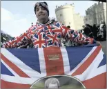  ??  ?? PATRIOTIC: A royal fan poses with a flag at St George’s Chapel in Windsor Castle. PICTURE: EPA