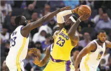  ?? Ezra Shaw / Getty Images ?? Draymond Green ( left) plays the kind of defense that can make life hard on top scorers, including the Lakers’ LeBron James.