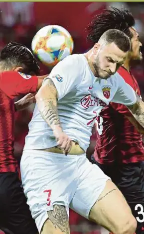  ?? AFP PIC ?? Shanghai SPIG’s Marko Arnautovic (front) fights for the ball with Urawa Red Diamonds players at Saitama Stadium on Tuesday.