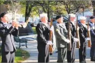  ??  ?? Steven Heintz plays taps on the trumpet as 10 members of the Northwest Honor Guard give a rifle salute.