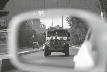  ?? ASSOCIATED PRESS ?? IN THIS AUG. 23, 2017, FILE PHOTO, of a car in Kabul, Afghanista­n. a patrolling U.S. armored vehicle is reflected in the mirror