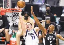  ?? MARK J. TERRILL AP ?? Mavericks’ Luka Doncic, who had a 31-point triple-double, goes to the basket past Clippers center Serge Ibaka.