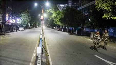  ?? AFP ?? Security personnel patrol a deserted street during the first day of a 21-day nationwide lockdown in Siliguri on Wednesday.