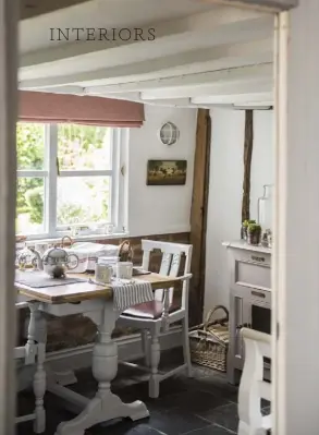  ??  ?? THIS PAGE, CLOCKWISE FROM ABOVE LEFT A 1930s oak table and chairs fits perfectly in the breakfast room; pale painted panelling and furniture is offset by the dark slate floor; an old butcher‘s block makes a statement in the kitchen OPPOSITE A...