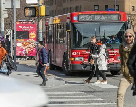  ?? Andrew Rush/Post-Gazette ?? A bus travels by the corner of De Soto Street and Fifth Avenue on Wednesday in Oakland. Mre than three dozen pedestrian accidents have occurred in the Oakland area in recent years, 10 of them involving Port Authority buses, according to a review of accident statistics from the Pennsylvan­ia Department of Transporta­tion and Port Authority.