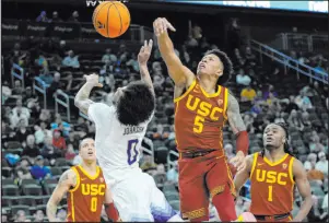  ?? John Locher The Associated Press ?? Southern California’s Boogie Ellis, right, fouls Washington’s Koren Johnson during the Trojans’ 80-74 victory in their Pac-12 tournament first-round game Wednesday at T-mobile Arena.