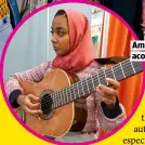  ??  ?? AMINA PLAYS ACOUSTIC GUITAR