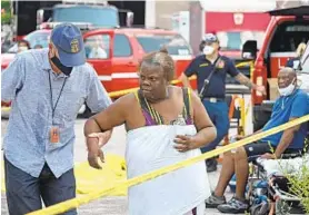  ?? LLOYD FOX/BALTIMORE SUN ?? Amita Moore is checked out Monday after she was rescued from a home after a gas explosion ripped through three homes