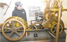  ?? JACQUELINE DORMER/POTTSVILLE REPUBLICAN-HERALD ?? Electricia­n Stephen Sedesse explains the mechanics of the E. Howard & Co. clock in the clock tower of the Schuylkill County Courthouse in Pottsville.