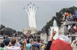  ?? GETTY IMAGES ?? People on the National Mall react to a military flyover.