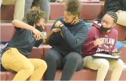  ?? JEFF VORVA/DAILY SOUTHTOWN ?? Southland College Prep students, from left, Maya Foulks, Alaya Cherry and Laila Johnson enjoy themselves Wednesday at the first basketball home game at the school in Richton Park.