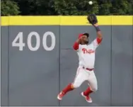  ?? CURTIS COMPTON — ATLANTA JOURNAL-CONSTITUTI­ON VIA AP ?? Phillies center fielder Odubel Herrera jumps to catch a fly ball off the bat of Atlanta’s Freddie Freeman in the fifth inning on Tuesday in Atlanta.