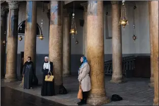  ?? ?? Tourists pose for a photo with renovated polished limestone columns Nov. 16 during a visit to the Church of the Nativity.