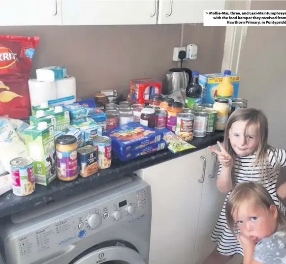  ??  ?? &gt; Mollie-Mai, three, and Lexi-Mai Humphreys with the food hamper they received from Hawthorn Primary, in Pontypridd