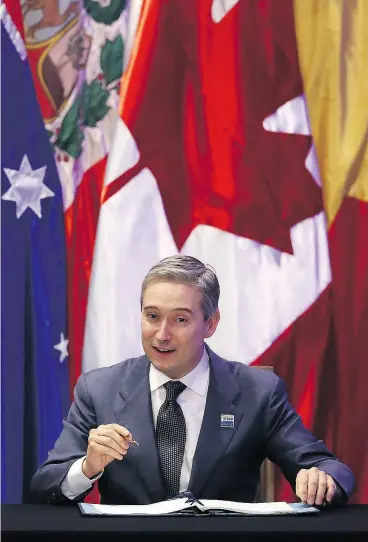  ?? CLAUDIO REYES / AFP / GETTY IMAGES ?? Trade Minister François-Philippe Champagne signs the Comprehens­ive and Progressiv­e Agreement for Trans-Pacific Partnershi­p on Thursday in Santiago.