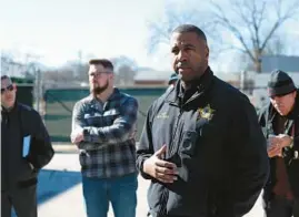  ?? TERRENCE ANTONIO JAMES/CHICAGO TRIBUNE ?? Aurora police Chief Keith Cross talks to mourners gathered outside the former Henry Pratt Co. building in Aurora on Feb. 15, the fifth anniversar­y of a mass shooting there. Police and fire department officials say that new gear and training are all part of preparing to deal with any active shooter situation in the future.