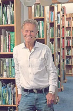  ??  ?? Alastair Johnston with the archive of golf books.