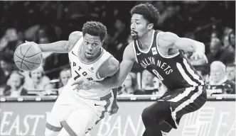  ?? KATHY WILLENS/THE ASSOCIATED PRESS ?? Raptors guard Kyler Lowry, driving against the Nets’ Spencer Dinwiddie on Tuesday. Toronto won 116-102.