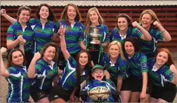  ??  ?? The Gorey Community School team, winners of the All-Ireland Schools sevens title, celebratin­g with their captain, Niamh Doran, and mentor, Matthew McGrath.