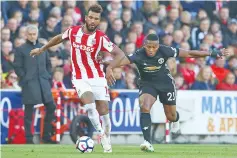  ??  ?? Stoke City’s German midfielder Eric Maxim Choupo-Moting (L) vies with Manchester United’s Ecuadorian midfielder Antonio Valencia (R) during the English Premier League football match between Stoke City and Manchester United at the Bet365 Stadium in...