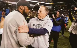  ?? Don Wright / Associated Press ?? Pittsburgh Steelers coach Mike Tomlin, left, and New England Patriots coach Bill Belichick talk on the field following a game in Pittsburgh in 2018.