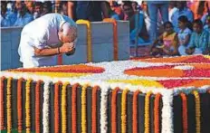  ?? AFP ?? Modi pays tribute to Gandhi at Raj Ghat in New Delhi, yesterday. He later visited Vijay Ghat.