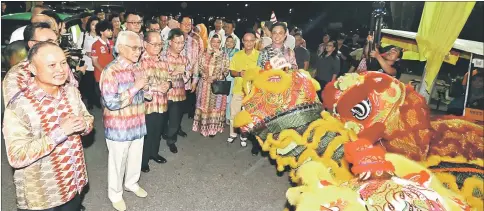  ??  ?? (Front, from left) Chan accompanie­s Taib, Uggah and Dr Sim upon their arrival at MBKS. Here, a lion dance performanc­e greets the dignitarie­s. — Photo by Kong JL