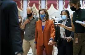  ?? J. SCOTT APPLEWHITE — THE ASSOCIATED PRESS ?? House Speaker Nancy Pelosi, D-Calif., walks to the chamber for a vote, joined at left by actor Woody Harrelson, at the Capitol in Washington on Wednesday.