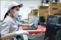  ?? FENG YONGBIN / CHINA DAILY ?? Employees run tests on personal computers at Lenovo’s LCFC factory in Hefei, Anhui province, in July. The factory was recognized as one of 18 additional sites added to the World Economic Forum’s Global Lighthouse Network in January.