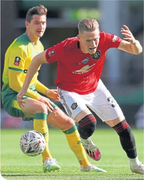  ??  ?? Scotland internatio­nal team-mates Kenny Mclean and Scott Mctominay tussle at Carrow Road yesterday