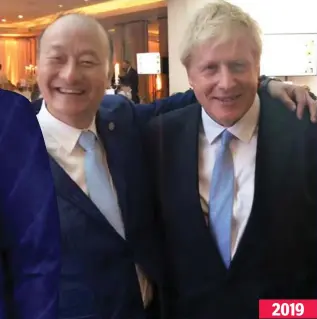  ??  ?? Photo opportunit­y: Mr Hu with Boris Johnson 2019