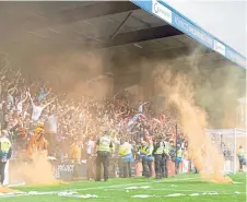  ?? ?? Dundee United fans “flare up” in Dingwall.