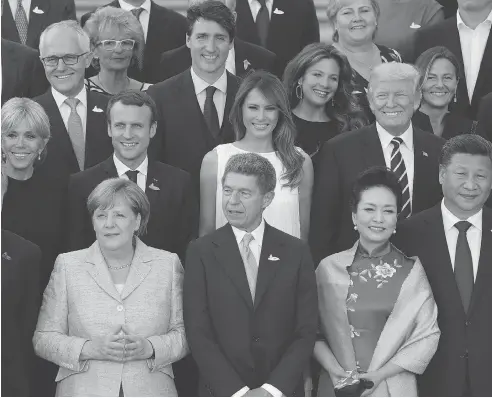 ??  ?? World leaders and their spouses — including Canadian Prime Minister Justin Trudeau and his wife Sophie Grégoire Trudeau — gather for a group photo in Hamburg on Friday. Outside the G20 meetings, an estimated 100,000 protesters continued demonstrat­ing...
