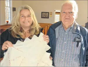  ?? DESIREE ANSTEY/JOURNAL PIONEER ?? Janelle Mann and her father, Sidney Drummond, hold the corner of an historical quilt that has their ancestors’ names embroidere­d on the patches.