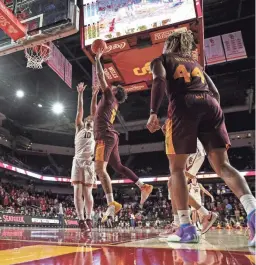 ?? AP ?? Arizona State guard Jose Perez (12) shoots against Southern California forward DJ Rodman (10) during the second half of Thursday’s game in Los Angeles. Southern California won 81-73.