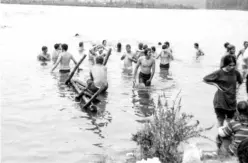  ??  ?? In this undated photo, festival goers take a dip in “the pond” at the Woodstock Music Festival during the week-end of August 15 to 18, 1969 in Bethel near Woodstock.