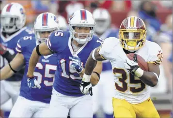  ?? NICK WASS/ASSOCIATED PRESS ?? Redskins running back Chris Thompson pulls away from Buffalo Bills defenders in the second half of Saturday’s game. The 30-7 loss was the least of Buffalo’s worries as oft-injured quarterbac­k Kevin Kolb left the game with concussion-like symptoms.