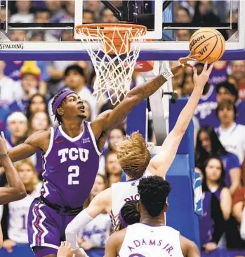  ?? NICK KRUG AP ?? TCU forward Emanuel Miller (2) blocks a shot by Kansas guard Gradey Dick during the second half.