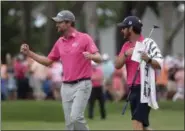  ?? LYNNE SLADKY — THE ASSOCIATED PRESS ?? Webb Simpson celebrates with his caddie Paul Tesori after winning the Players Championsh­ip on May 13 in Ponte Vedra Beach, Fla.