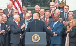  ?? JIM LO SCALZO/EPA-EFE ?? President Trump and Republican­s from the House and Senate, celebrate the passage of the GOP tax plan at the White House.