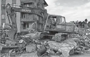  ?? BERNAT ARMANGUE/AP ?? Rescue workers search for bodies and earthquake survivors Saturday on a collapsed building in Antakya, southeaste­rn Turkey.