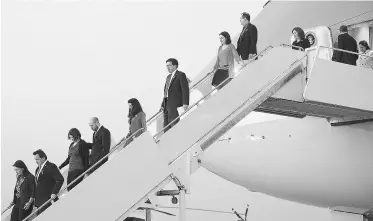  ?? MANDEL NGAN/AFP/GETTY IMAGES ?? Family members of Newtown, Conn. school shooting victims step off Air Force One with U.S. President Barack Obama at Andrews Air Force Base in Maryland.