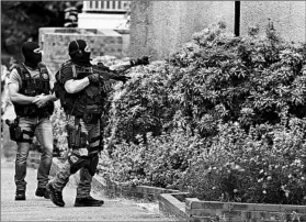 ?? FRANCOIS MORI/AP ?? French officers search Saint-Etienne-du-Rouvray village after a fatal church raid Tuesday.