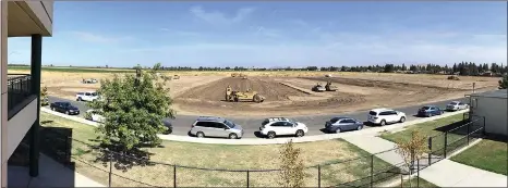  ?? RECORDER PHOTO BY CHIEKO HARA ?? Workers break ground Tuesday at the Burton School District’s new constructi­on site next to Summit Charter Collegiate Academy.