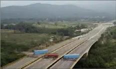  ?? The Associated Press ?? A fuel tanker, cargo trailers and makeshift fencing block the Tienditas Internatio­nal Bridge in an attempt to stop humanitari­an aid entering Venezuela from Colombia.